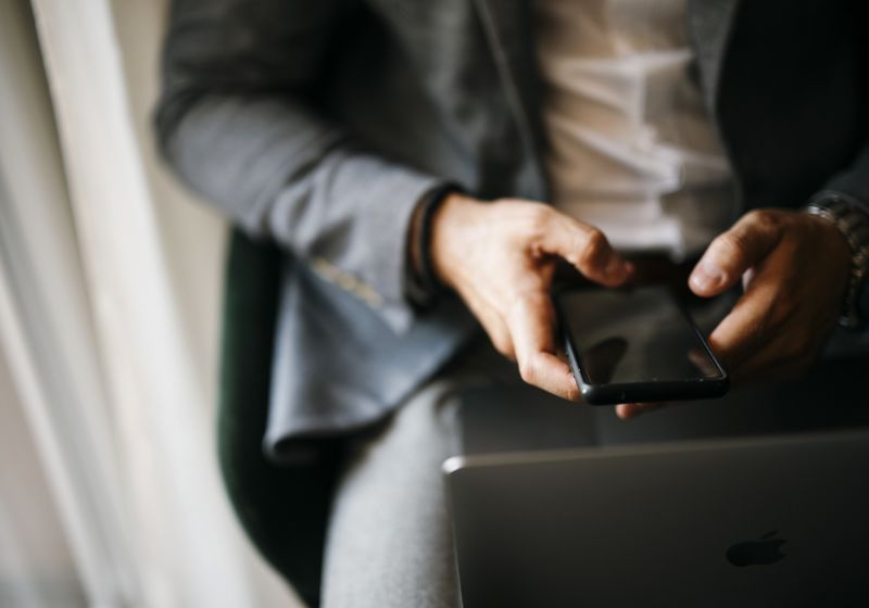Smartphone and laptop in hands