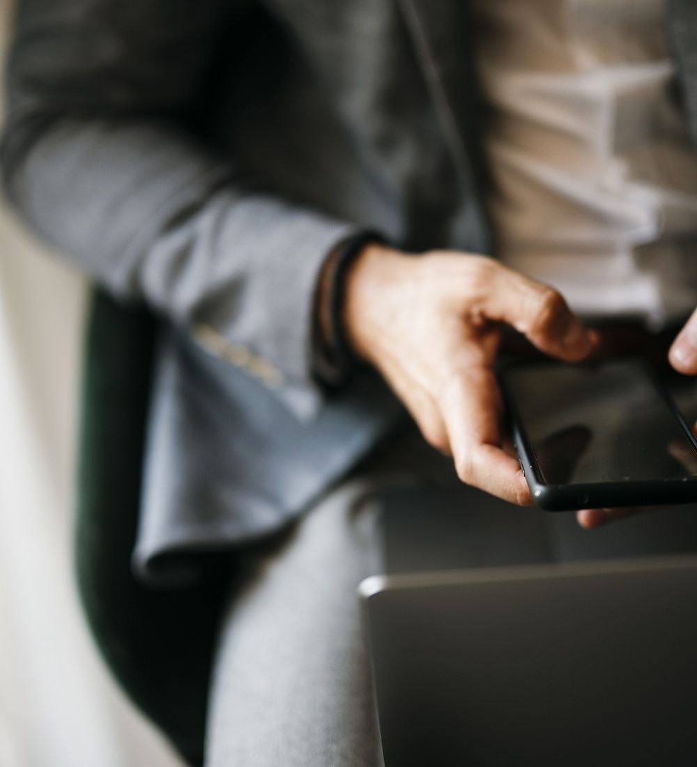 Smartphone and laptop in hands